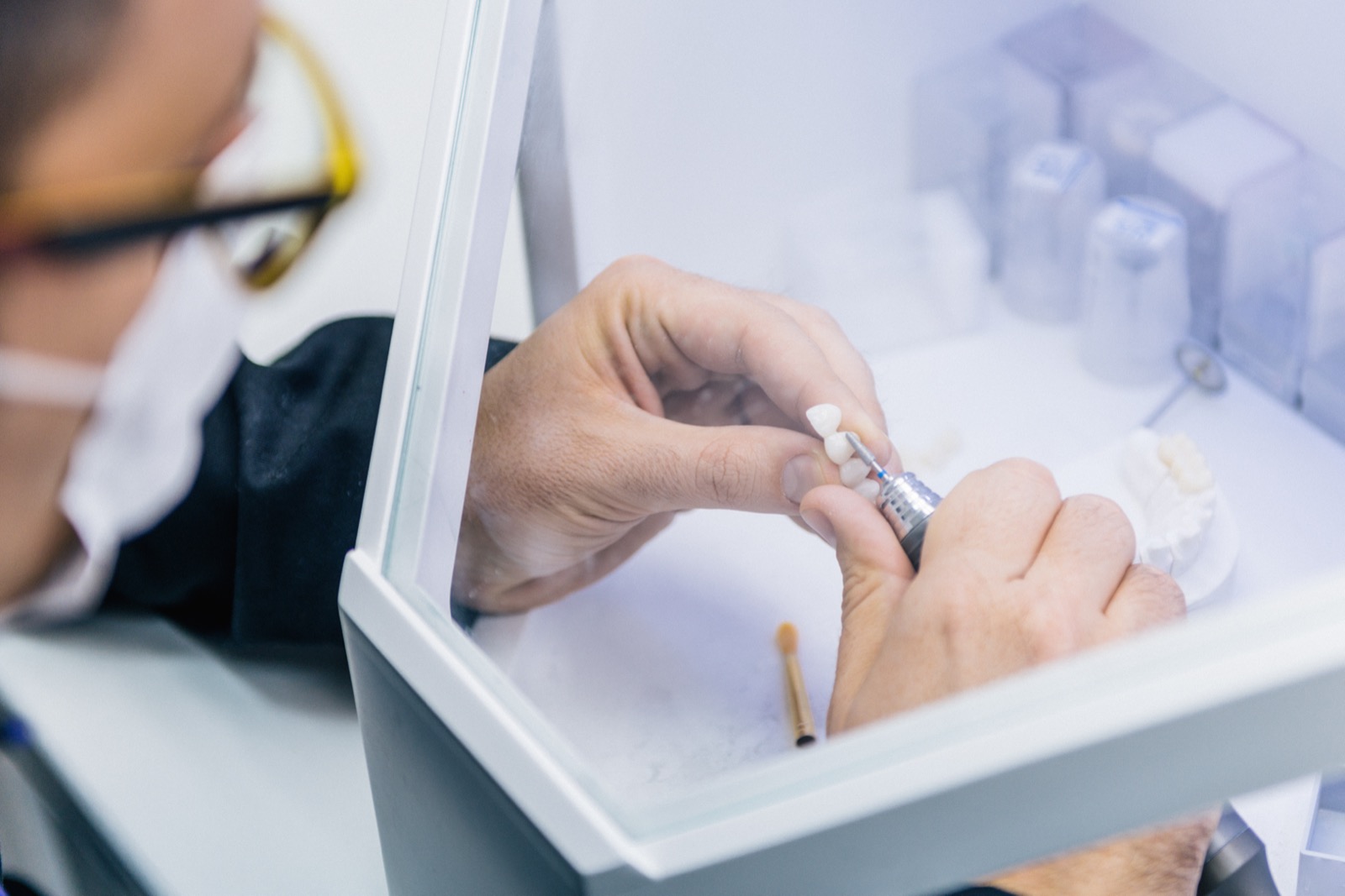 Dental technician or dentist working with tooth dentures in his laboratory